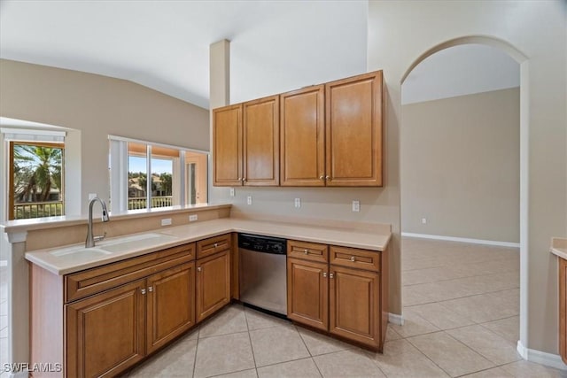 kitchen with dishwasher, light countertops, brown cabinetry, and a sink