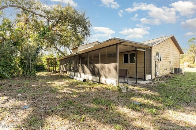 exterior space featuring cooling unit and a sunroom