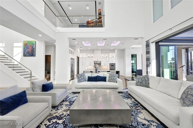 living room featuring a towering ceiling