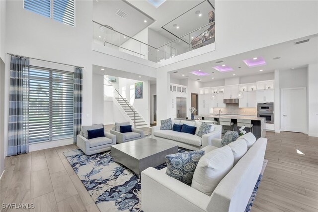 living room featuring a high ceiling and sink