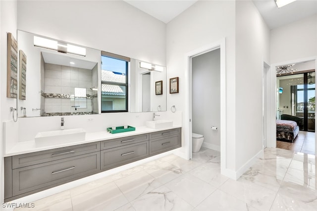 bathroom featuring a shower, toilet, and vanity