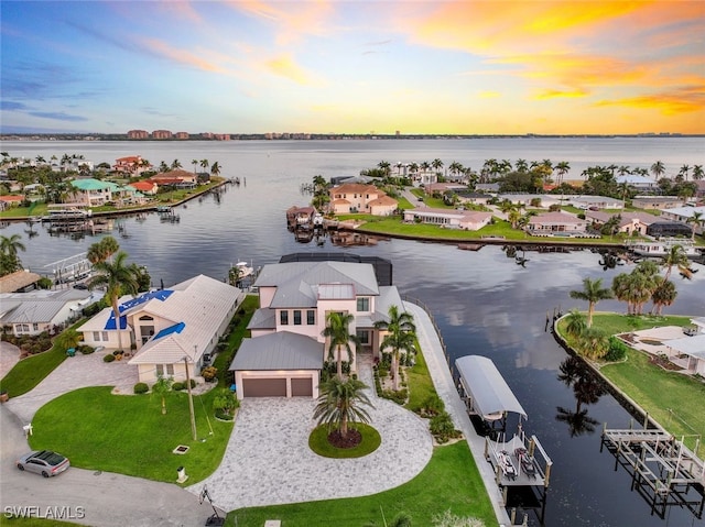 aerial view at dusk with a water view