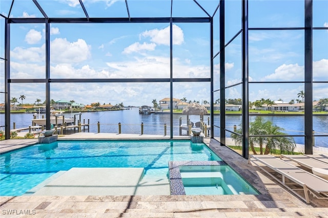 view of pool featuring an in ground hot tub, a dock, glass enclosure, and a water view