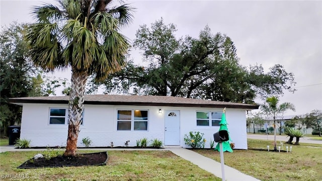 ranch-style home featuring a front yard