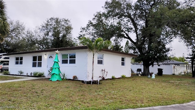 ranch-style house with a front lawn