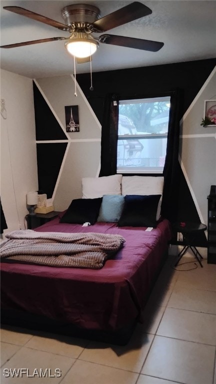 tiled bedroom featuring ceiling fan