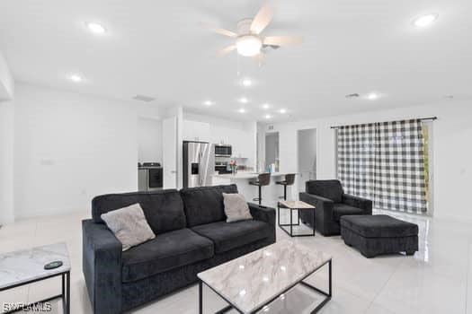 living room with light tile patterned floors and ceiling fan