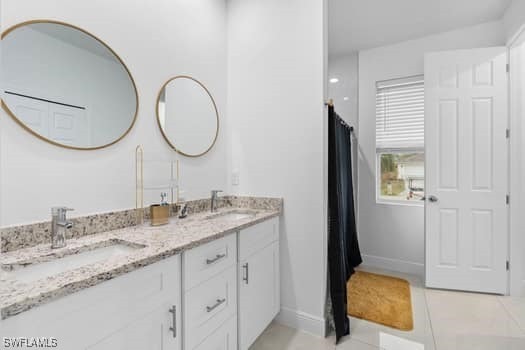 bathroom featuring tile patterned floors and vanity