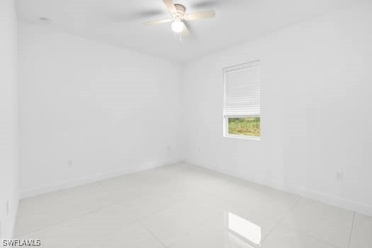 tiled empty room with ceiling fan