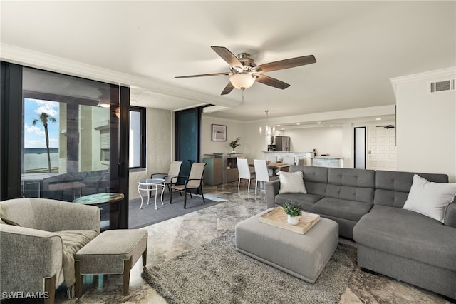 living room featuring ceiling fan and ornamental molding