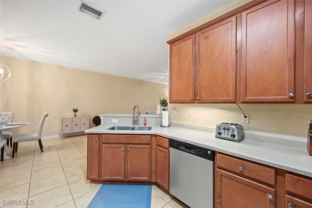 kitchen featuring visible vents, light countertops, stainless steel dishwasher, light tile patterned flooring, and a sink