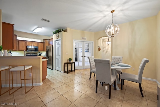 dining area with light tile patterned flooring, visible vents, french doors, and an inviting chandelier