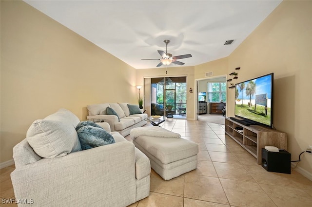 living area with light tile patterned flooring, baseboards, visible vents, and ceiling fan