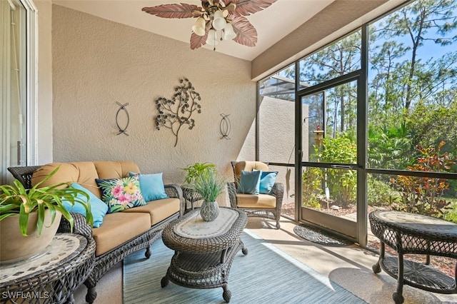 sunroom featuring a ceiling fan