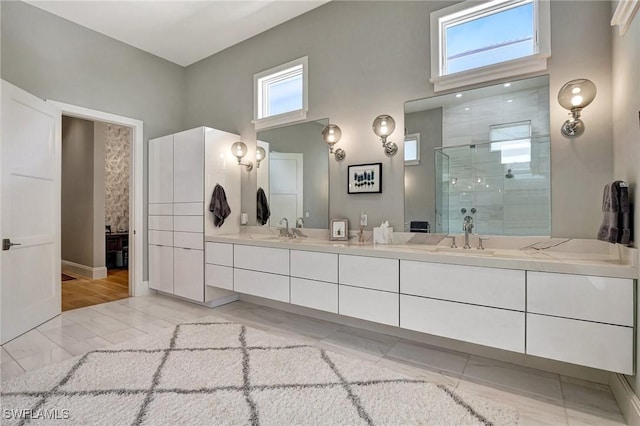 bathroom with a healthy amount of sunlight, vanity, and a shower with shower door