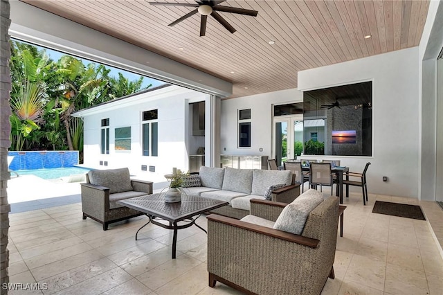 view of patio with an outdoor living space and ceiling fan