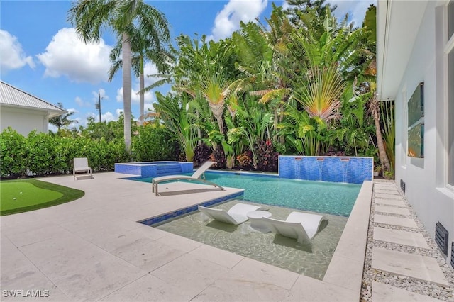 view of swimming pool with an in ground hot tub, pool water feature, and a patio