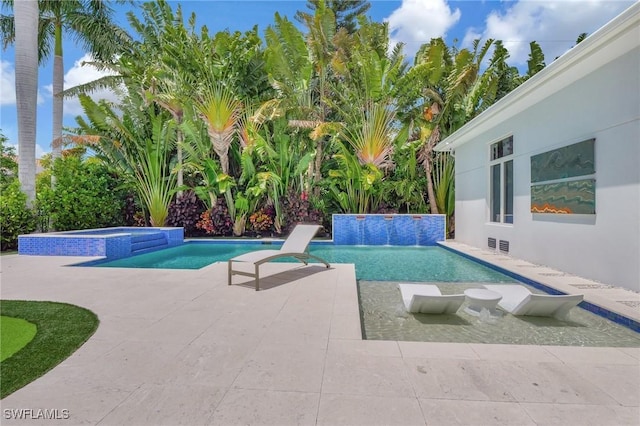 view of swimming pool with an in ground hot tub, pool water feature, and a patio