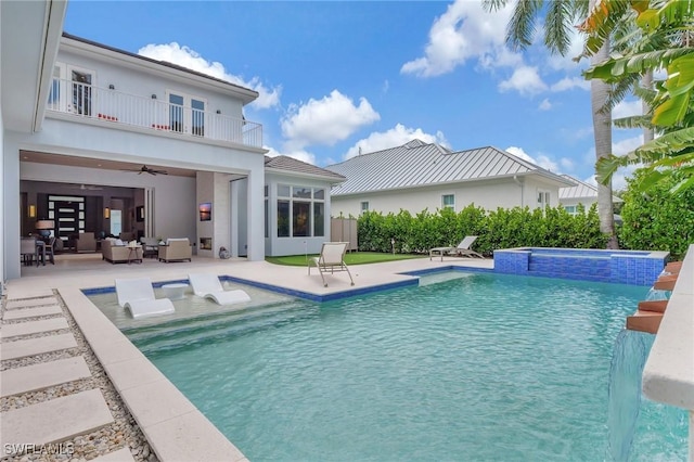 exterior space with ceiling fan, a patio area, pool water feature, and a balcony