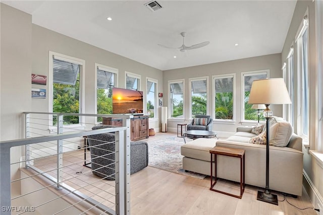 living room with wood-type flooring and ceiling fan