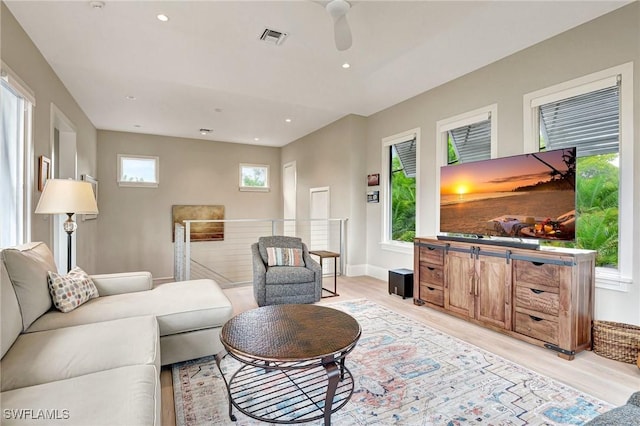 living room with ceiling fan and light wood-type flooring