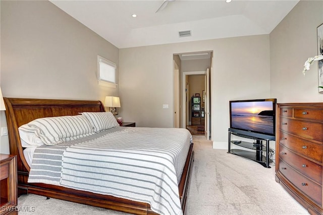 bedroom featuring light colored carpet and a tray ceiling