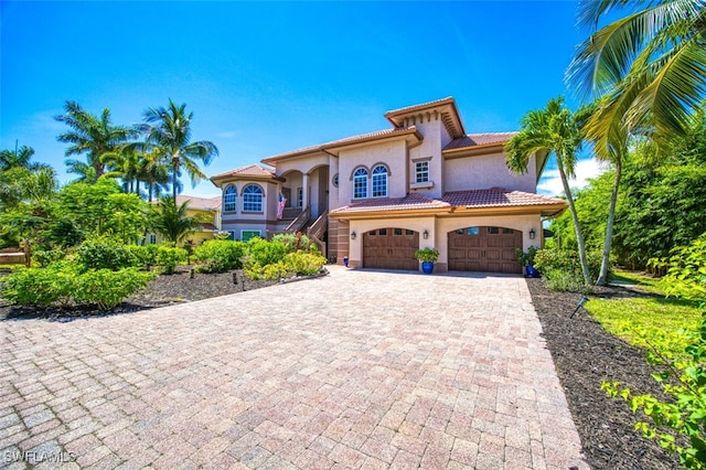 mediterranean / spanish-style house with a garage