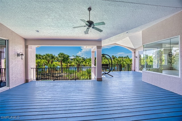 wooden terrace featuring ceiling fan