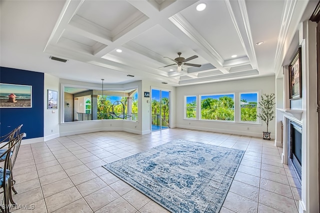 unfurnished living room featuring coffered ceiling, light tile patterned floors, and plenty of natural light