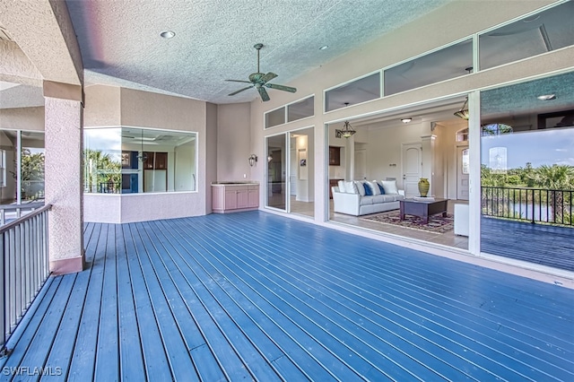 deck featuring a water view, an outdoor hangout area, and ceiling fan