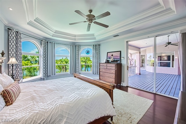 bedroom with a raised ceiling, ornamental molding, dark wood-type flooring, and ceiling fan