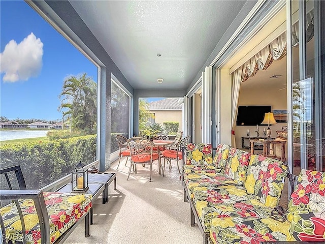 sunroom / solarium featuring a water view