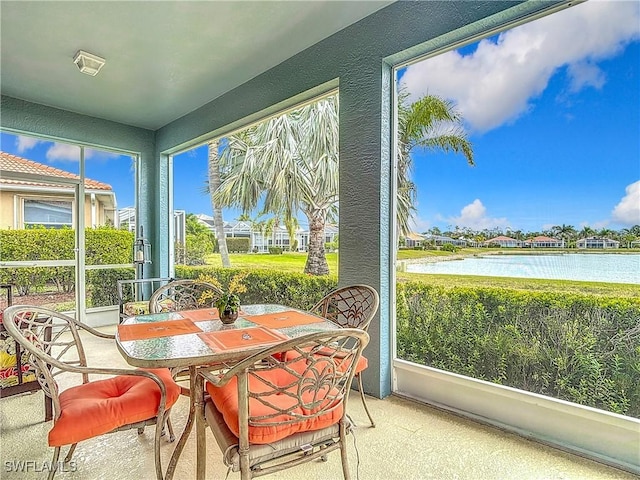 sunroom / solarium with a water view and a wealth of natural light