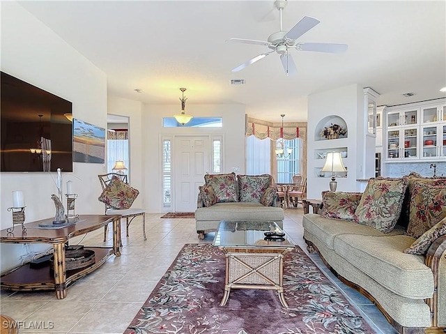 living room with light tile patterned floors, built in features, and ceiling fan