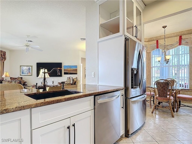 kitchen featuring white cabinetry, appliances with stainless steel finishes, sink, and stone countertops