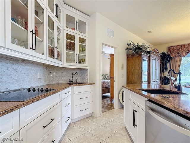 kitchen with white cabinetry, sink, dishwasher, and black electric stovetop