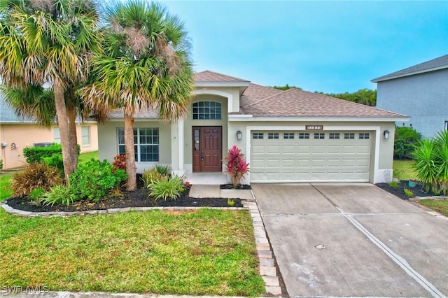 view of front facade featuring a garage and a front lawn