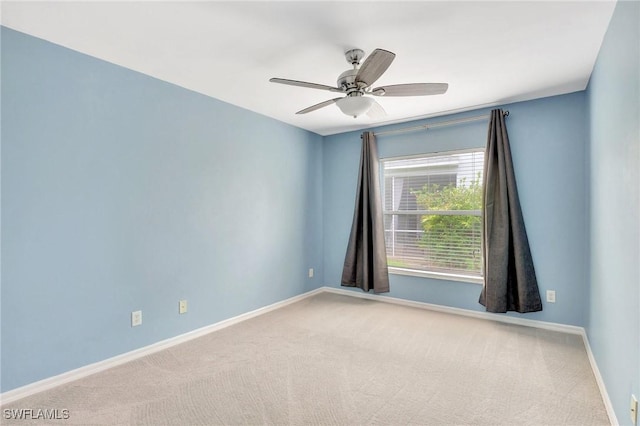 empty room featuring ceiling fan and carpet flooring