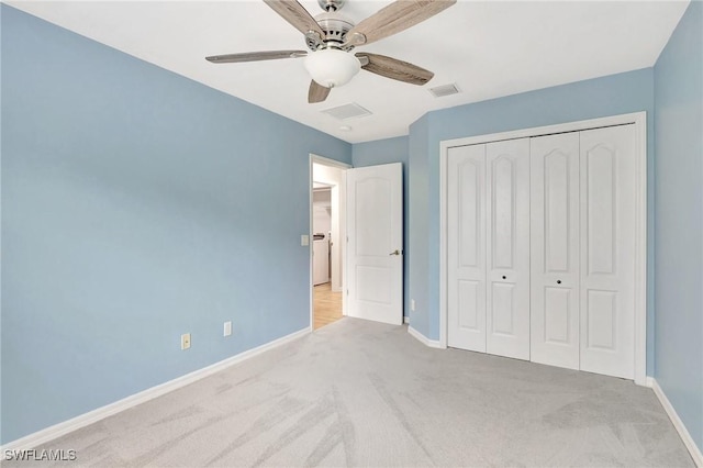 unfurnished bedroom featuring light colored carpet, a closet, and ceiling fan