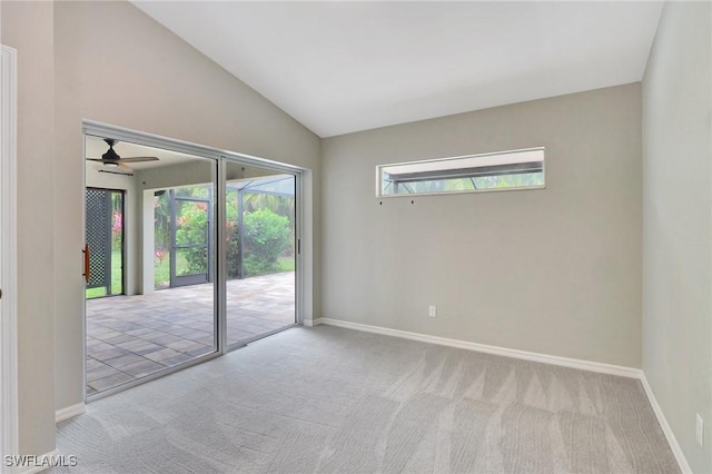 spare room with vaulted ceiling, light carpet, and ceiling fan