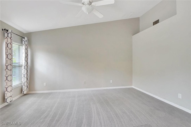 unfurnished room with plenty of natural light, light colored carpet, and ceiling fan