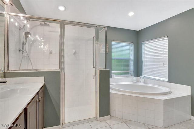 bathroom with tile patterned flooring, vanity, and independent shower and bath