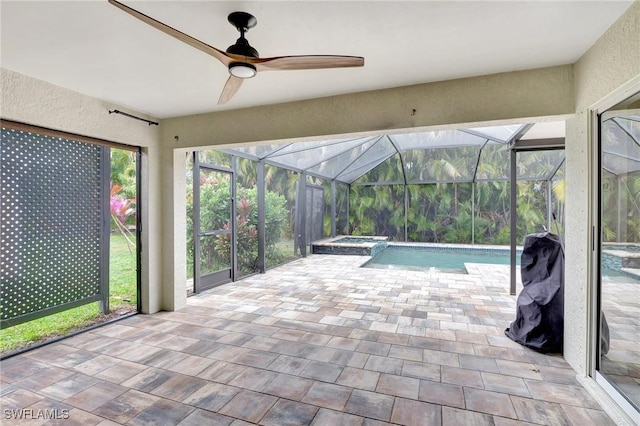 unfurnished sunroom featuring ceiling fan