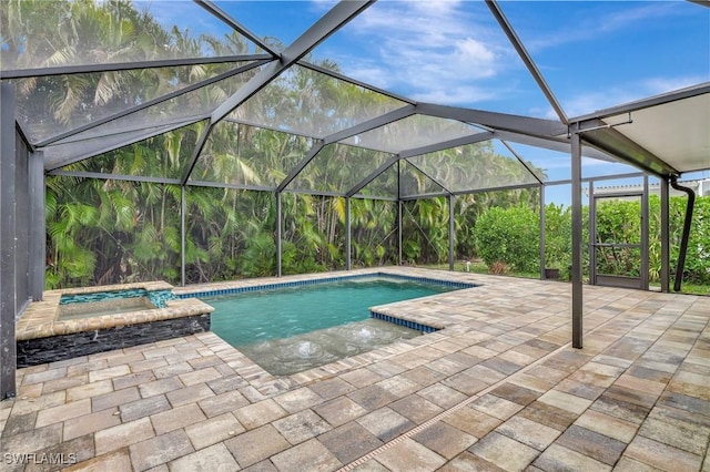 view of pool featuring an in ground hot tub, a lanai, and a patio area