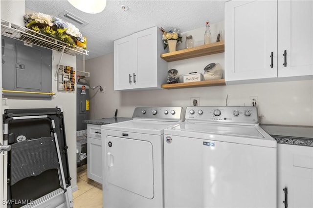 laundry room featuring cabinets, light tile patterned flooring, a textured ceiling, and independent washer and dryer