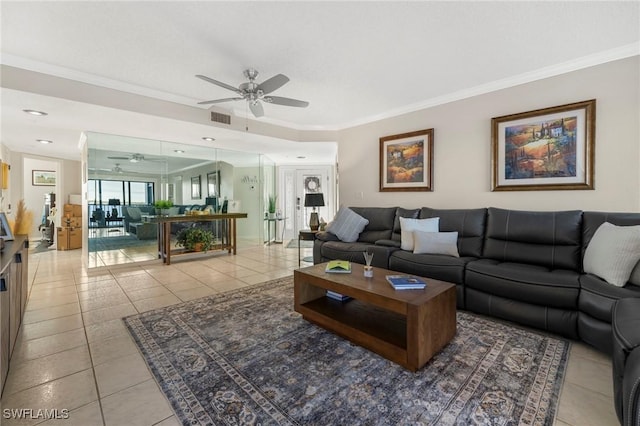 tiled living room featuring ceiling fan and ornamental molding