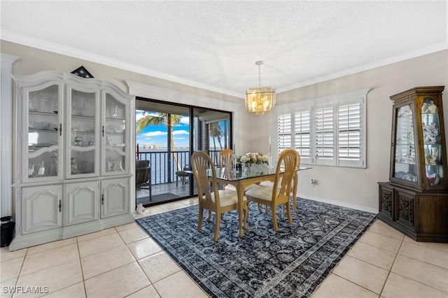 dining area featuring crown molding, an inviting chandelier, a textured ceiling, and light tile patterned floors