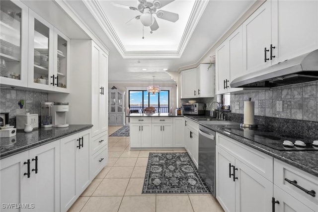 kitchen with white cabinetry, ornamental molding, light tile patterned flooring, stainless steel dishwasher, and a raised ceiling