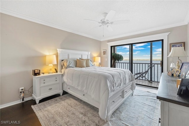 bedroom with ceiling fan, a water view, a textured ceiling, dark hardwood / wood-style flooring, and access to outside