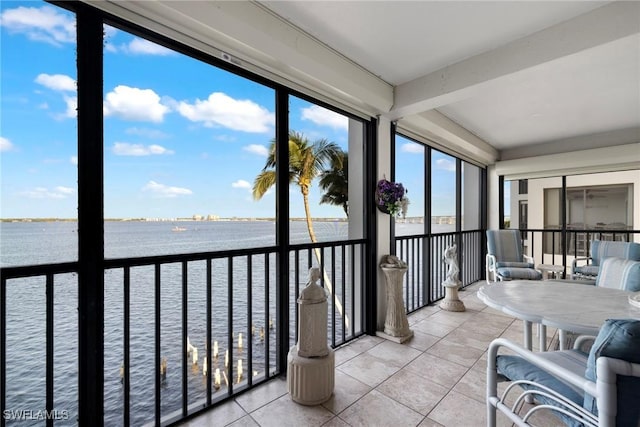 sunroom / solarium featuring a water view and a wealth of natural light